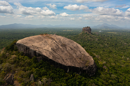Sigiriya mountain and Pidurangala rock among the dense forest on the island of Sri Lanka. Tropical green forest and jungle.